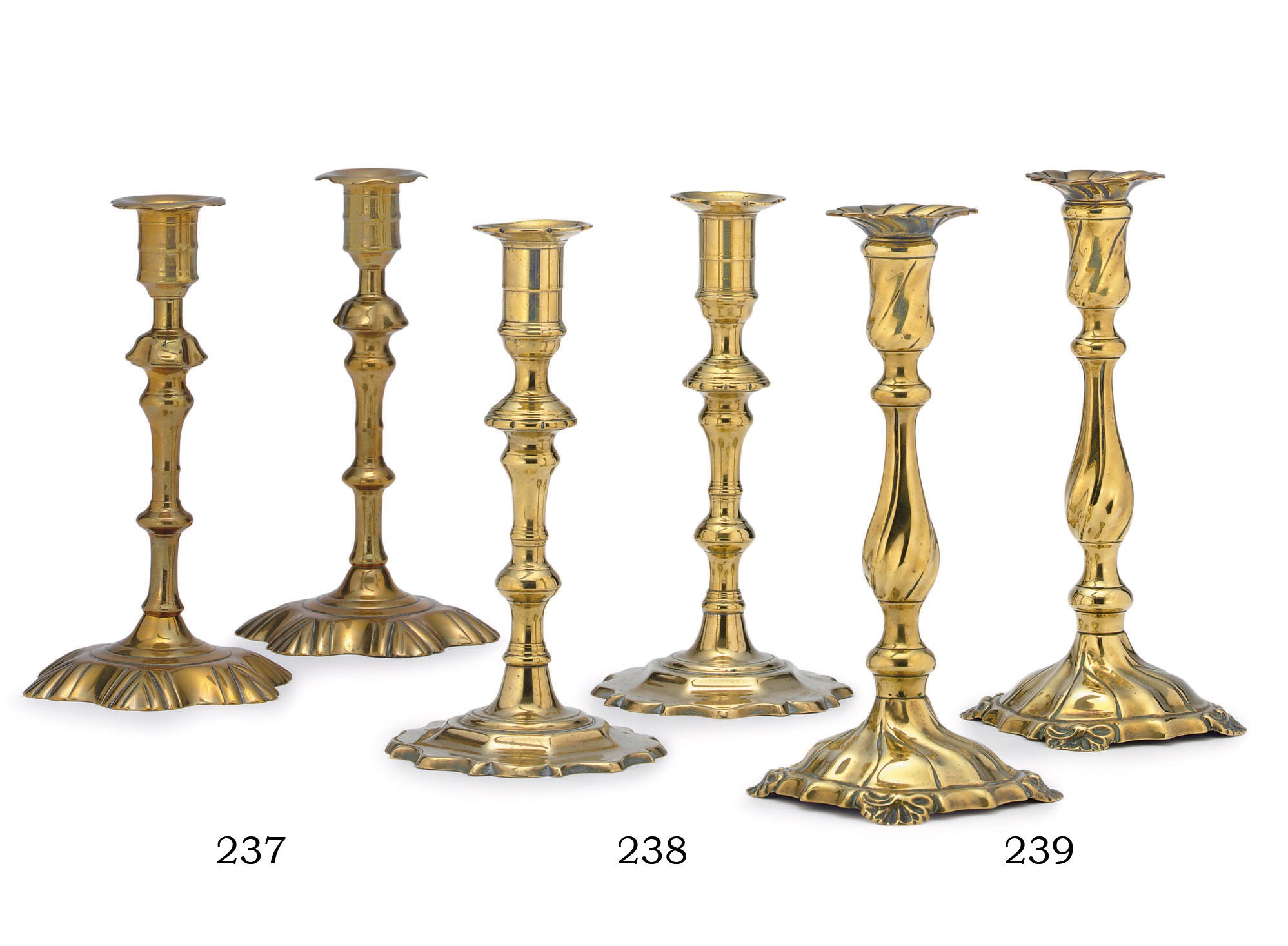 A PAIR OF GEORGE II SWIRL AND SHELL-BASE BRASS CANDLESTICKS