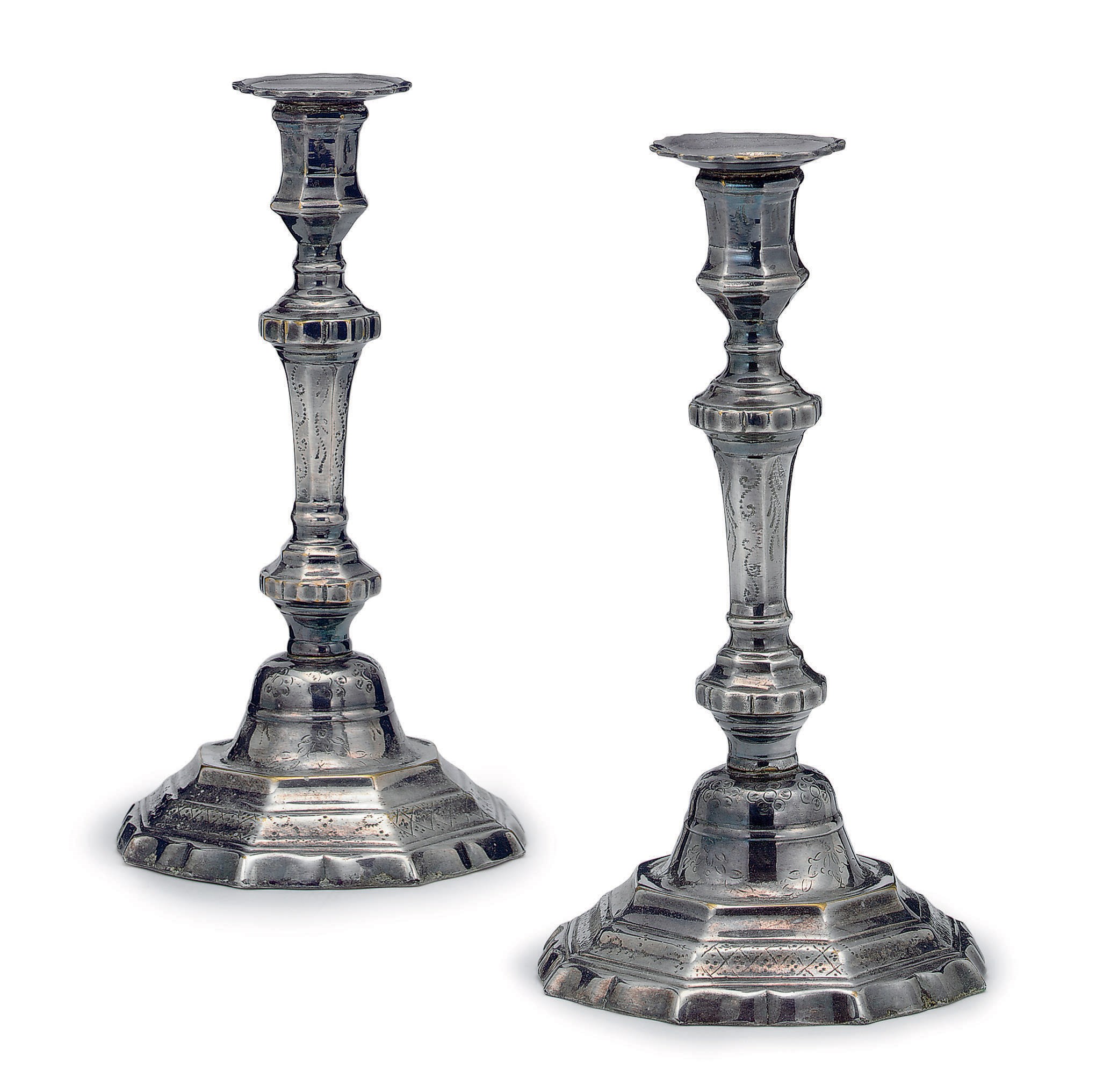 A PAIR OF ENGRAVED SILVERED BRASS CANDLESTICKS