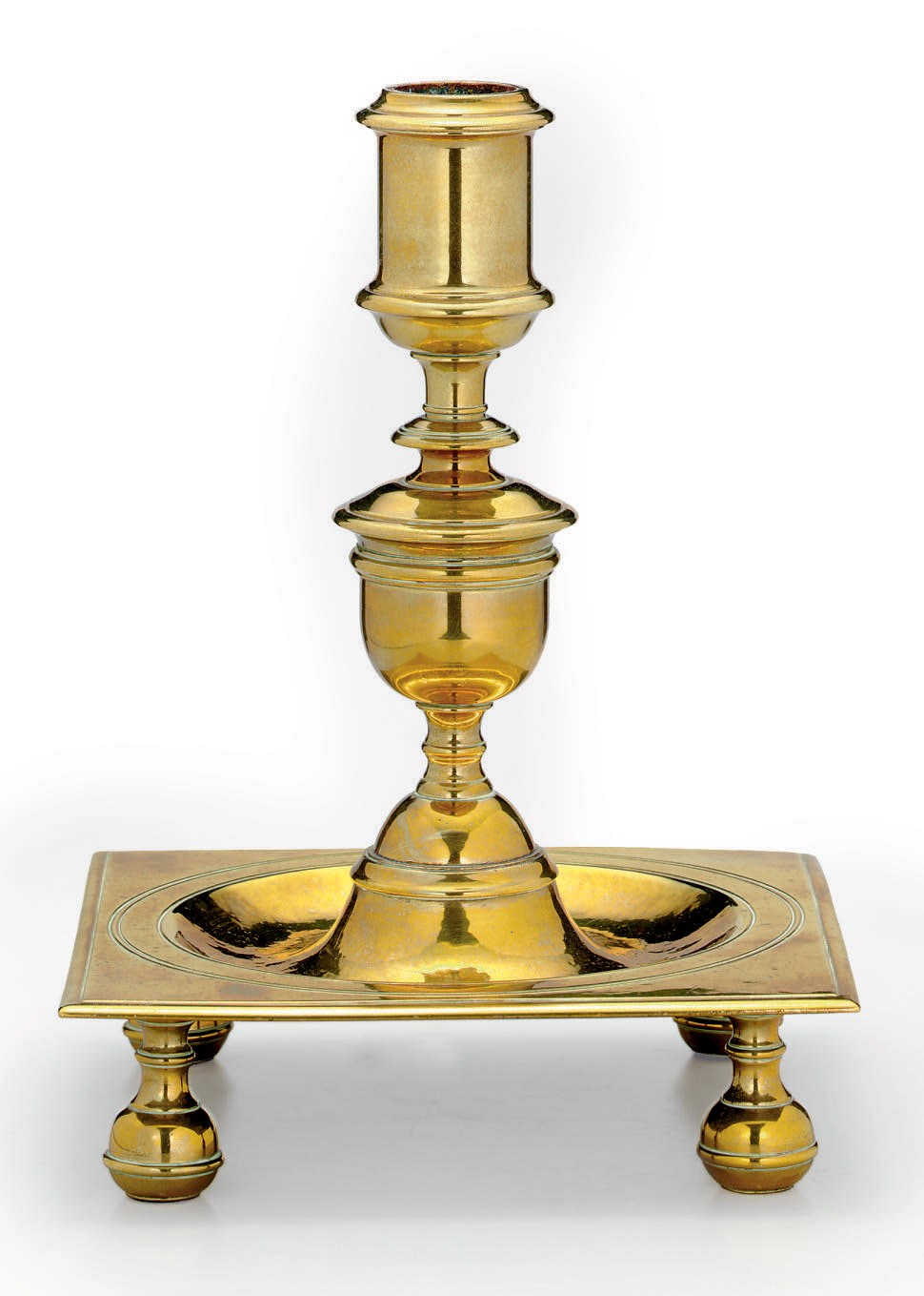 A CAST-BRASS CANDLESTICK