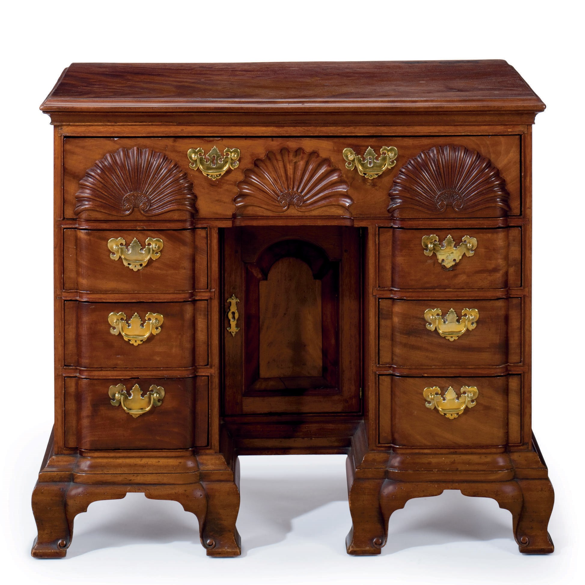 A QUEEN ANNE CARVED AND FIGURED MAHOGANY BLOCK-FRONT KNEEHOLE DESK