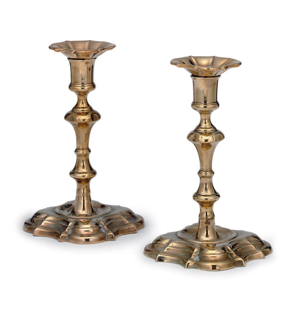 A PAIR OF GEORGE III SILVER-FORM QUATREFOIL-BASE BRASS CANDLESTICKS