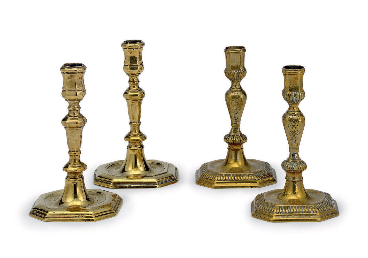 A PAIR OF WILLIAM AND MARY ENGRAVED BRASS CANDLESTICKS