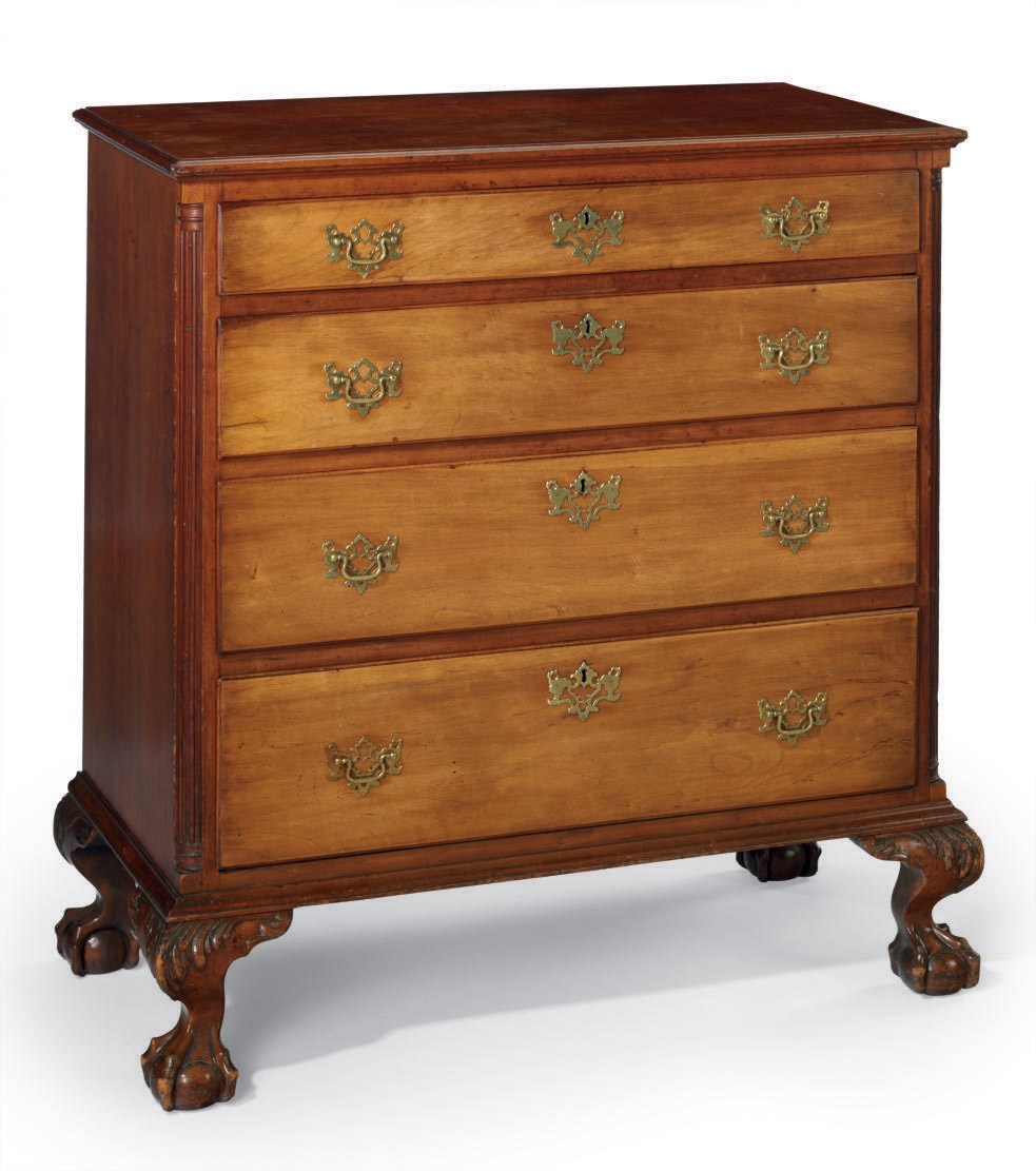 A CHIPPENDALE CARVED AND FIGURED WALNUT CHEST-OF-DRAWERS