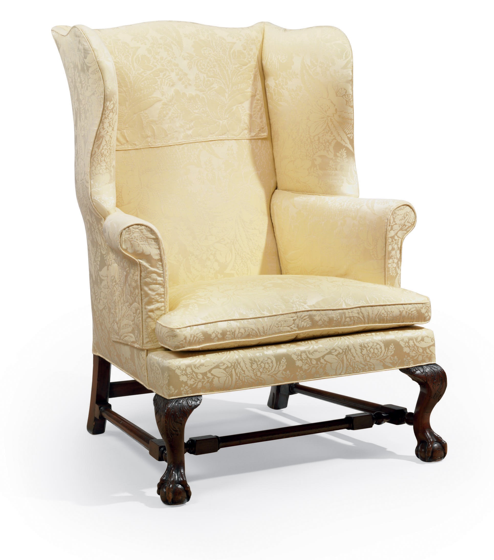 A CHIPPENDALE CARVED AND FIGURED MAHOGANY EASY CHAIR