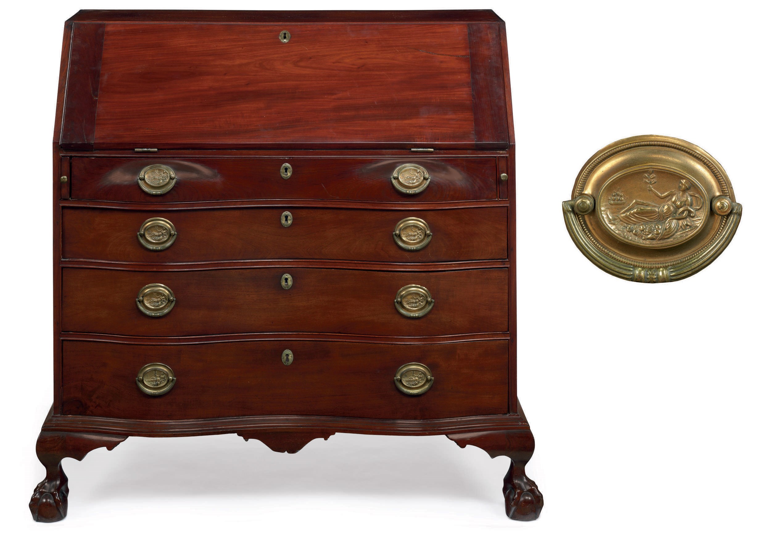 A CHIPPENDALE CARVED MAHOGANY REVERSE-SERPENTINE SLANT-FRONT DESK