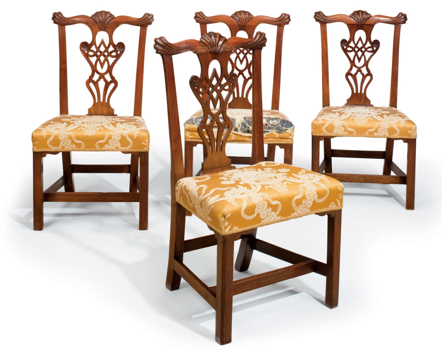 A SET OF FOUR CHIPPENDALE WALNUT DINING CHAIRS