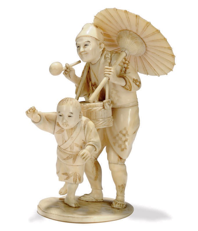 A JAPANESE IVORY OKIMONO OF A PEDLAR, SIGNED