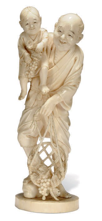 A JAPANESE IVORY OKIMONO OF AN ELDERLY MAN AND CHILD, SIGNED