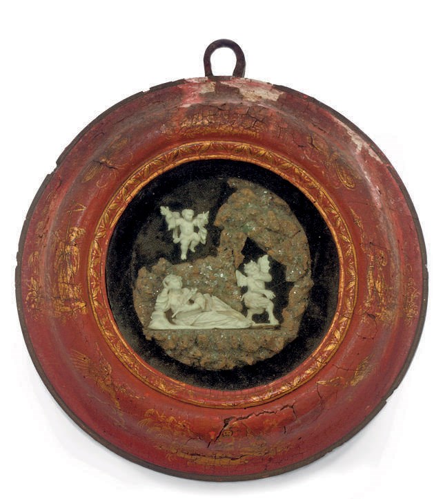 AN ITALIAN CARVED IVORY RELIEF OF A FEMALE SAINT AND A DEVIL