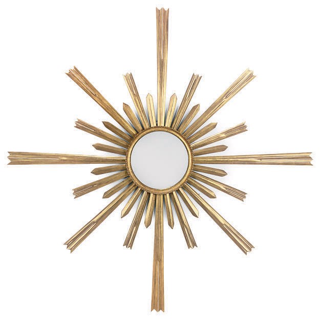 A CARVED GILTWOOD AND COMPOSITION SUN-BURST MIRROR