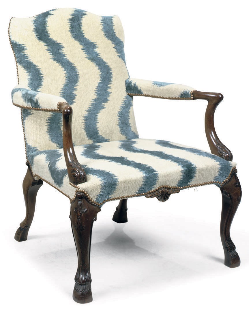 AN IRISH CARVED MAHOGANY GAINSBOROUGH ARMCHAIR
