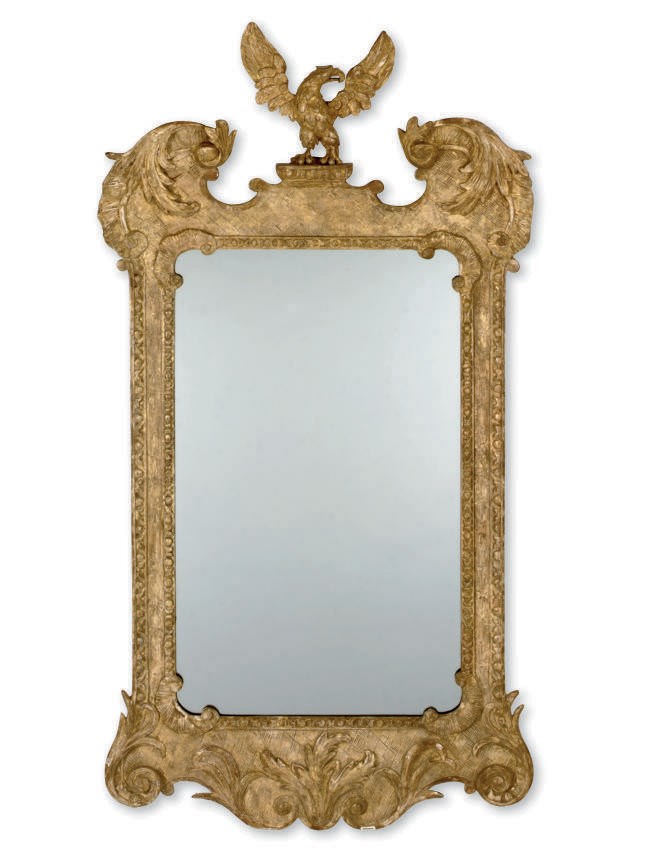 A CARVED GILTWOOD AND COMPOSITION MIRROR