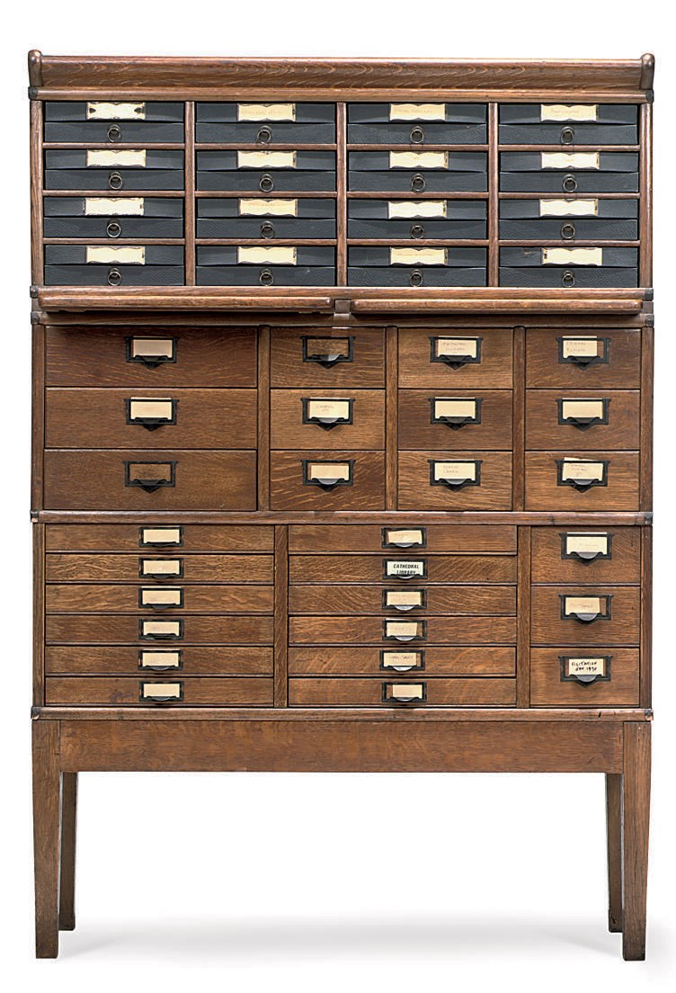 A METAL-BANDED OAK THREE SECTION FILING CABINET