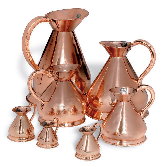A MATCHED SET OF SEVEN ASSORTED COPPER WINE MEASURES