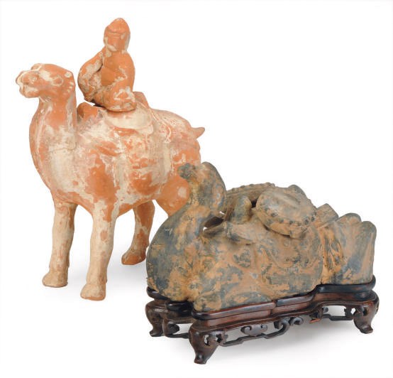 A CHINESE WEI-STYLE GREY POTTERY RECUMBENT CAMEL AND A TANG-STYLE PAINTED POTTERY CAMEL AND RIDER