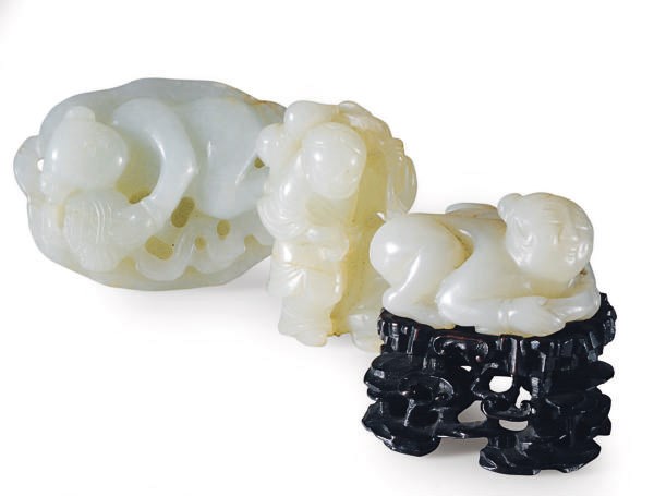 THREE CHINESE CARVED PALE GREENISH-WHITE JADE CARVINGS OF BOYS,