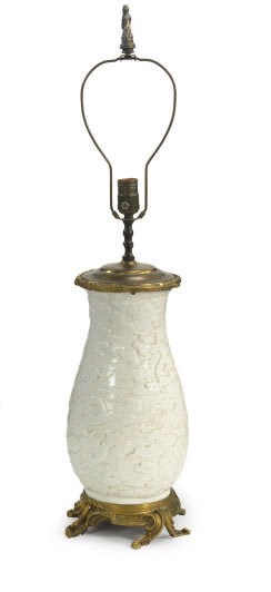 A WHITE-GLAZED CHINOISERIE STYLE VASE MOUNTED AS A LAMP,