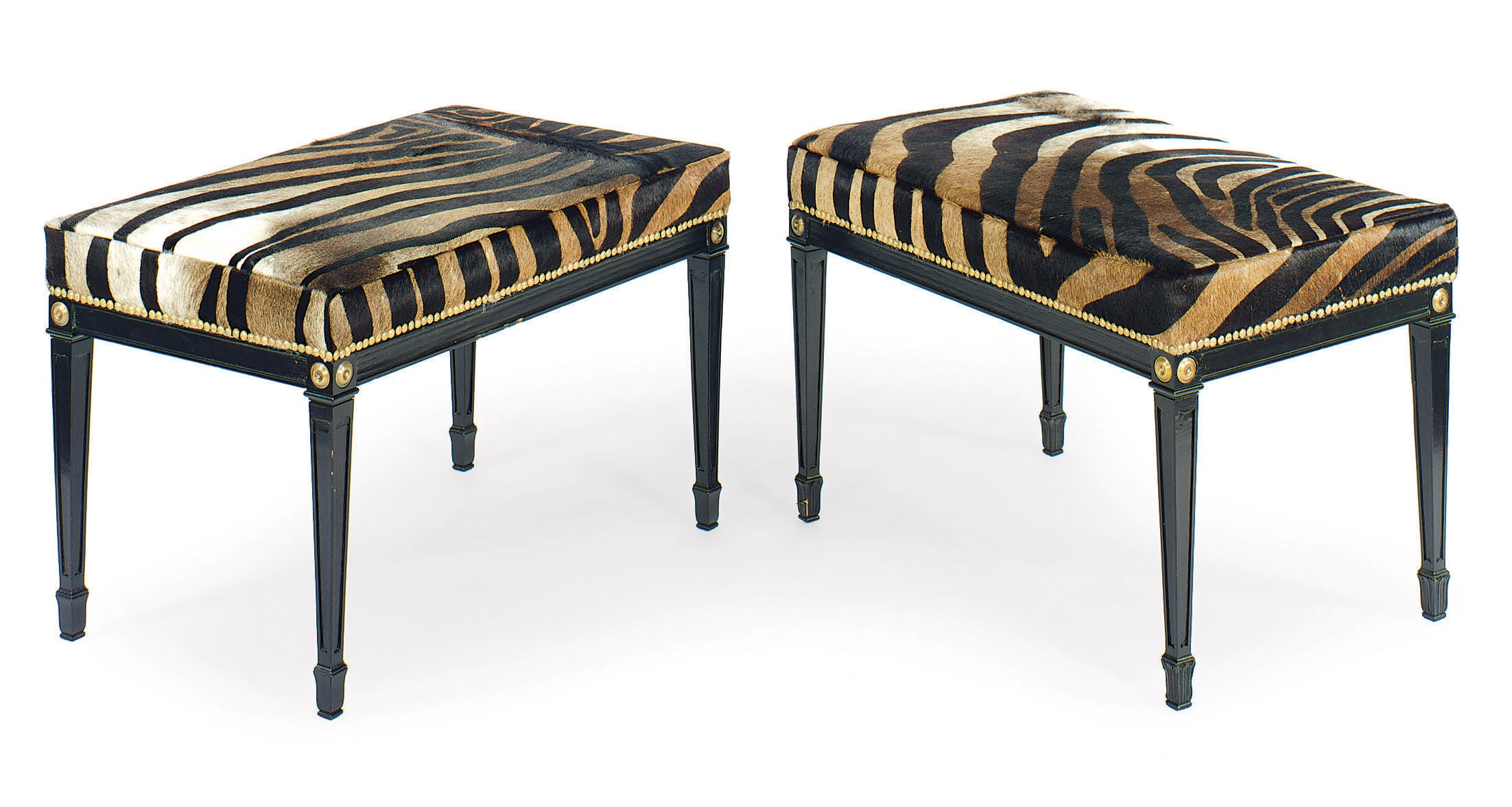 A PAIR OF EBONIZED AND ZEBRA SKIN UPHOLSTERED BENCHES,