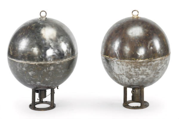 A PAIR OF POLISHED IRON INDUSTRIAL SPHERES,