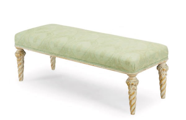 A CREAM-PAINTED AND PARCEL-GILT BENCH,