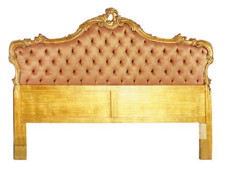 A GILTWOOD AND UPHOLSTERD HEADBOARD,