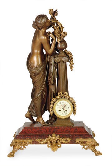 A PATINATED AND GILT-WHITE METAL FIGURAL MANTLE CLOCK,