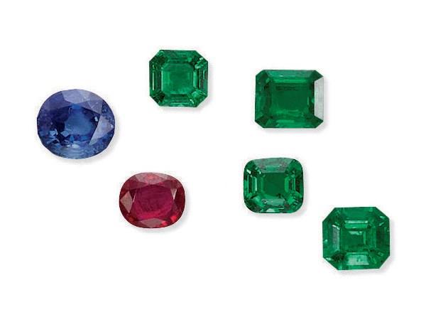 A GROUP OF SIX UNMOUNTED COLOURED GEMSTONES