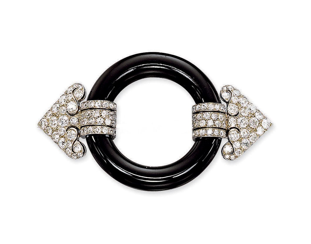 AN ART DECO ONYX AND DIAMOND BUCKLE BROOCH, BY CARTIER