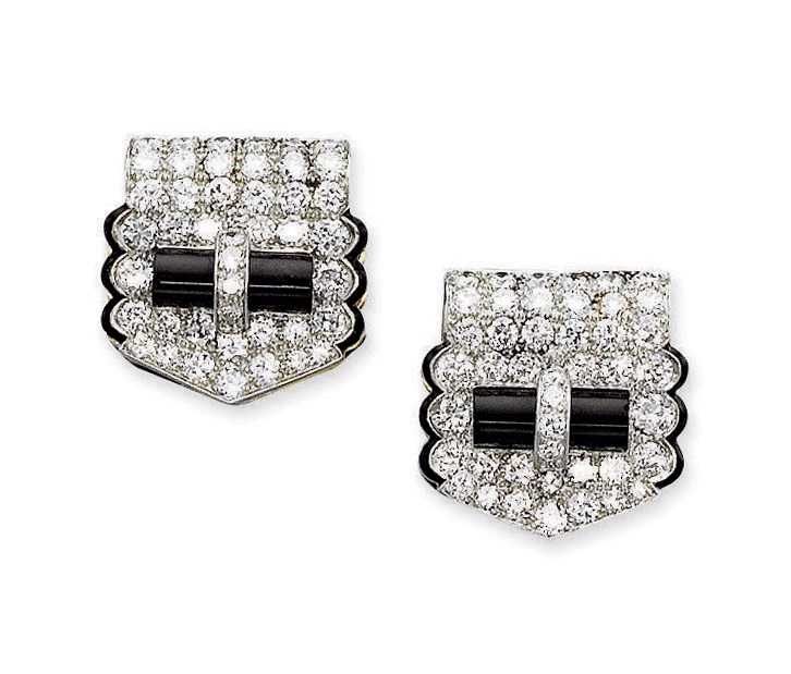 A PAIR OF ART DECO ONYX AND DIAMOND CLIPS, BY CARTIER
