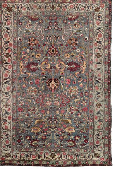 An antique Kirman rug