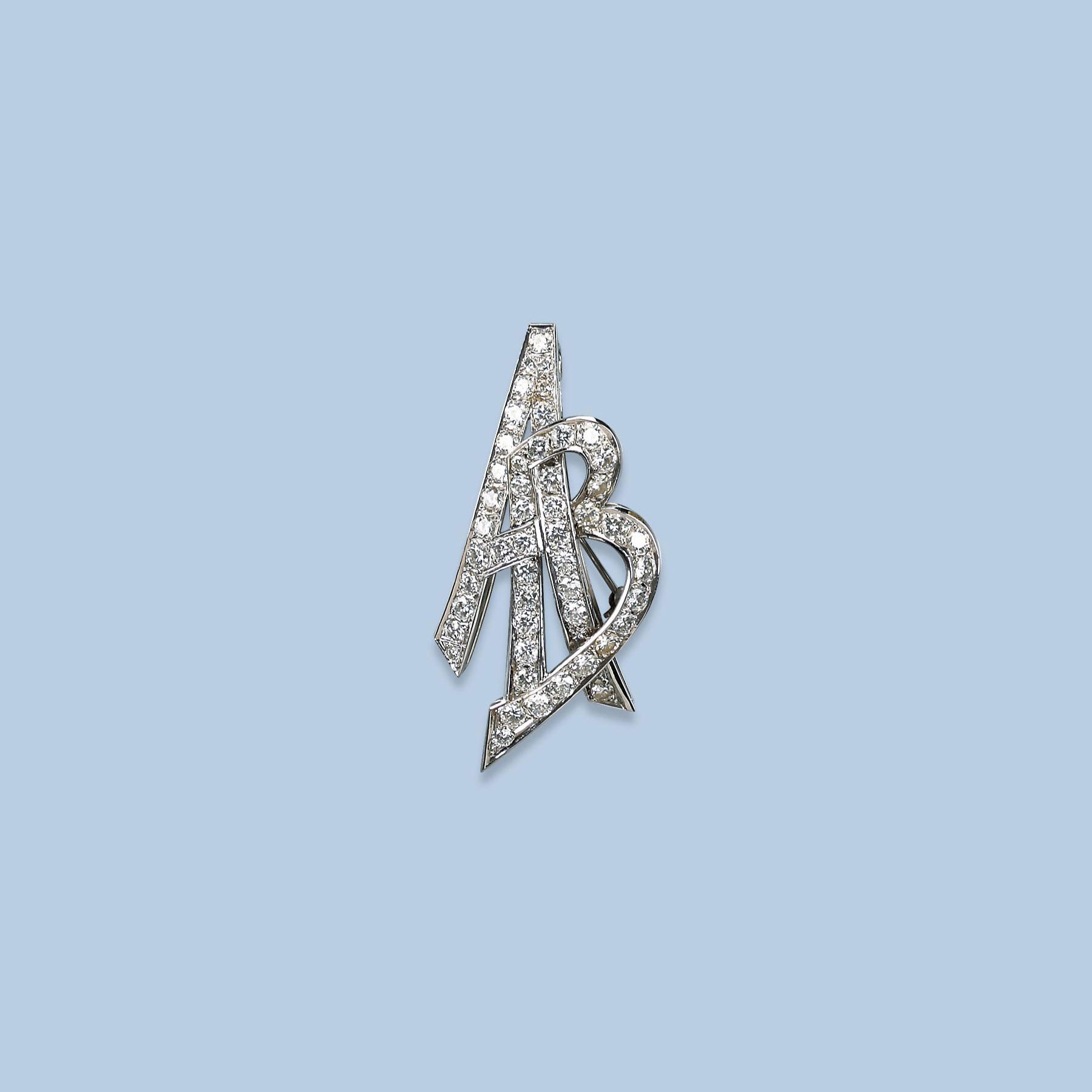 A DIAMOND MONOGRAM BROOCH