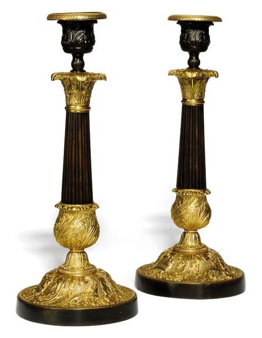 A PAIR OF GILT AND PATINATED BRONZE CANDLESTICKS