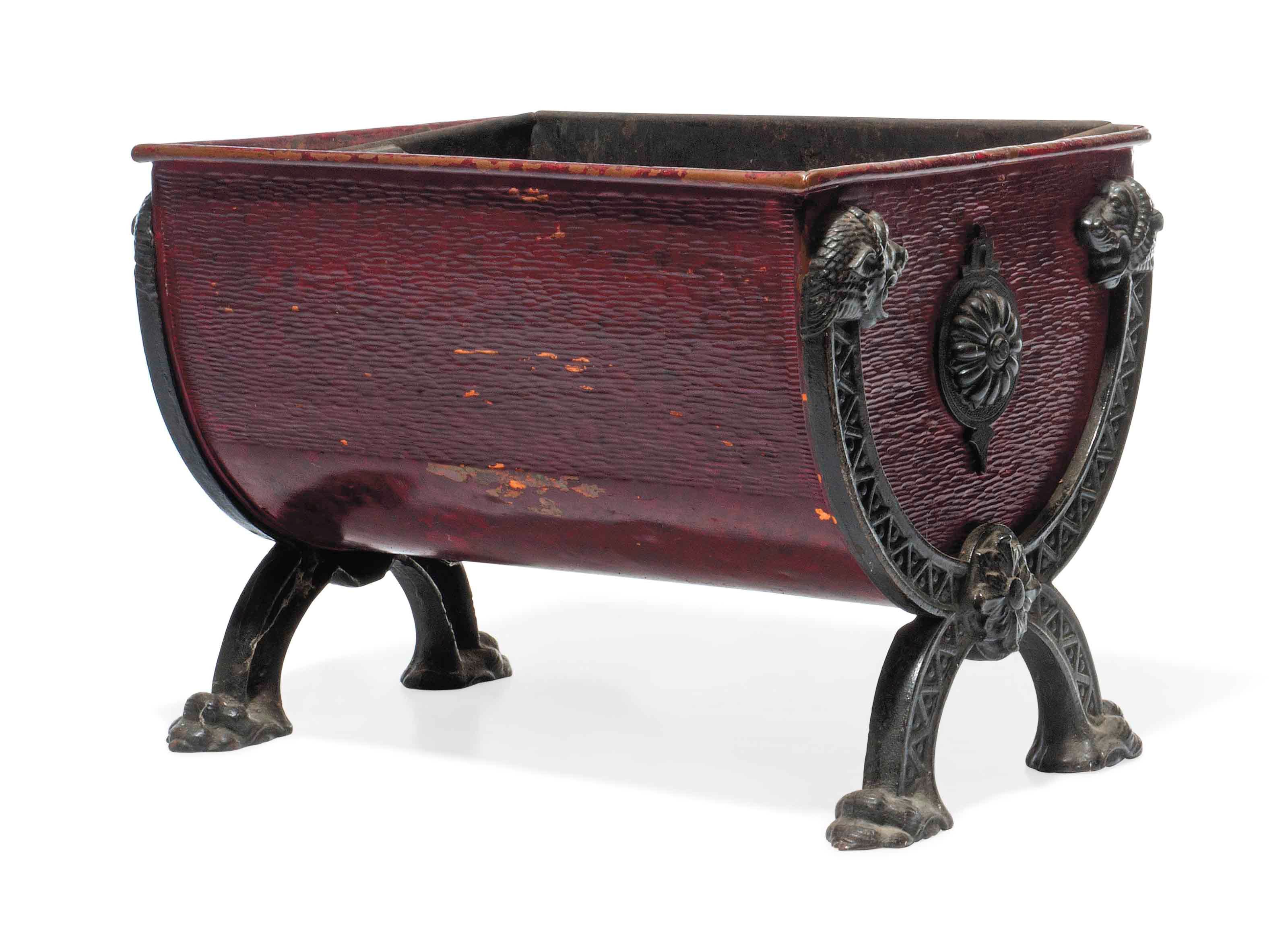 A VICTORIAN CAST-IRON AND RED TÔLE-PEINTE LOG BASKET