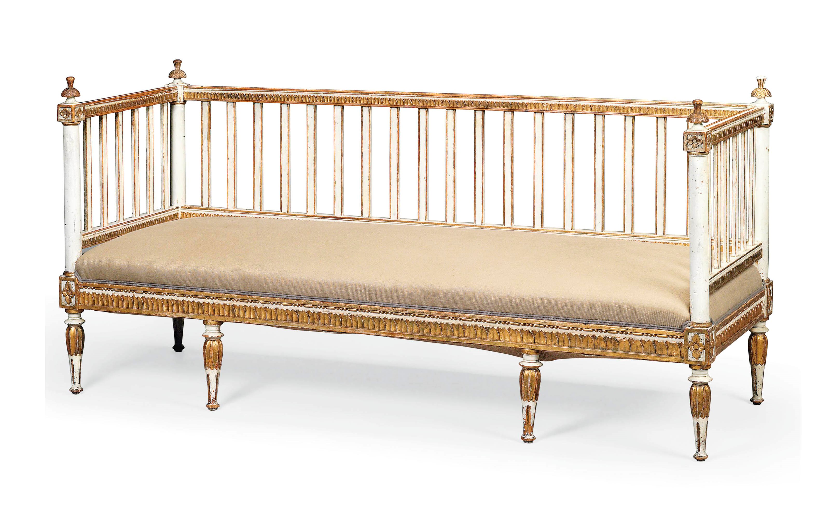 A NORTH EUROPEAN NEO-CLASSICAL CREAM-PAINTED AND PARCEL-GILT SOFA