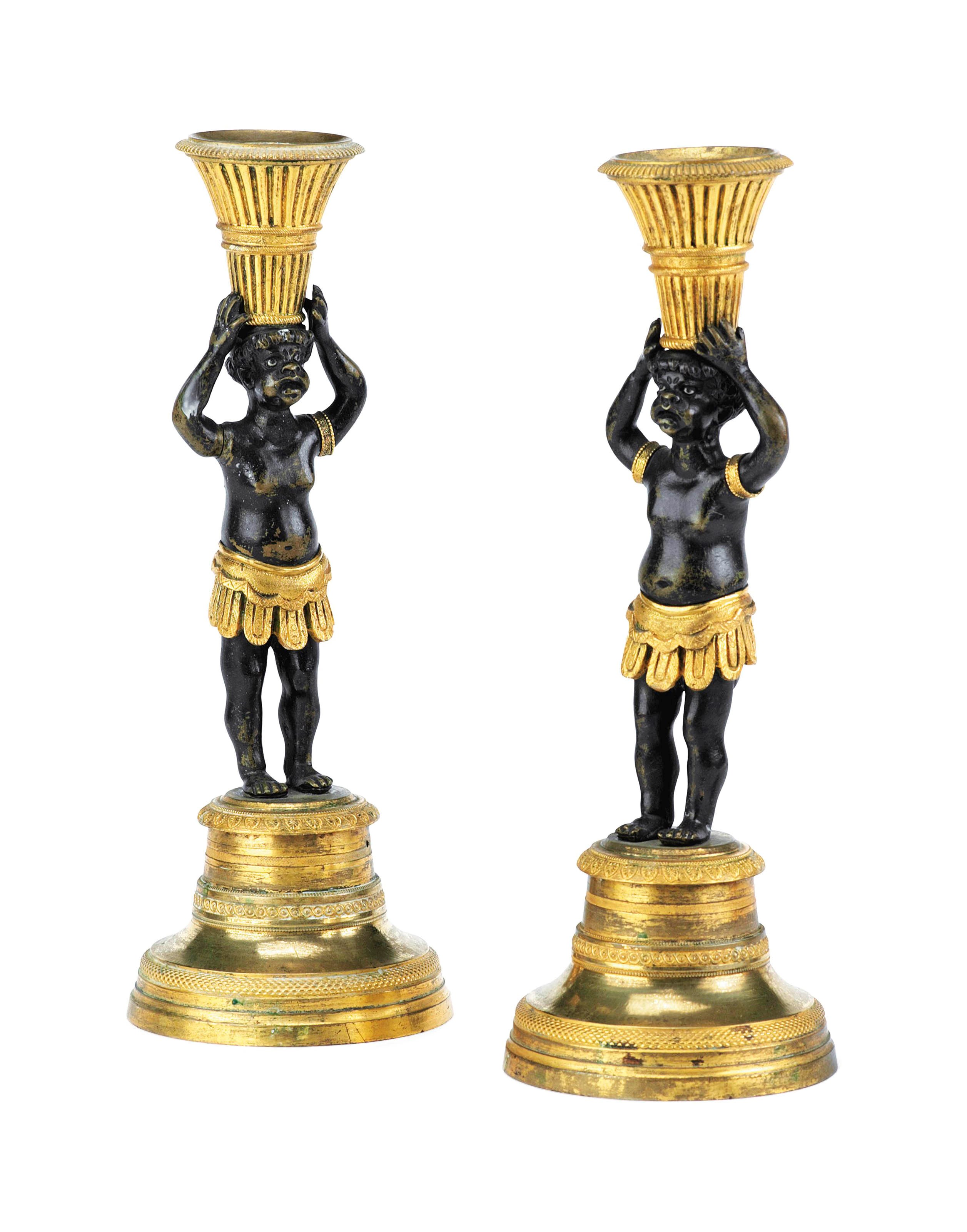 A PAIR OF EMPIRE ORMOLU AND BRONZE CANDLESTICKS