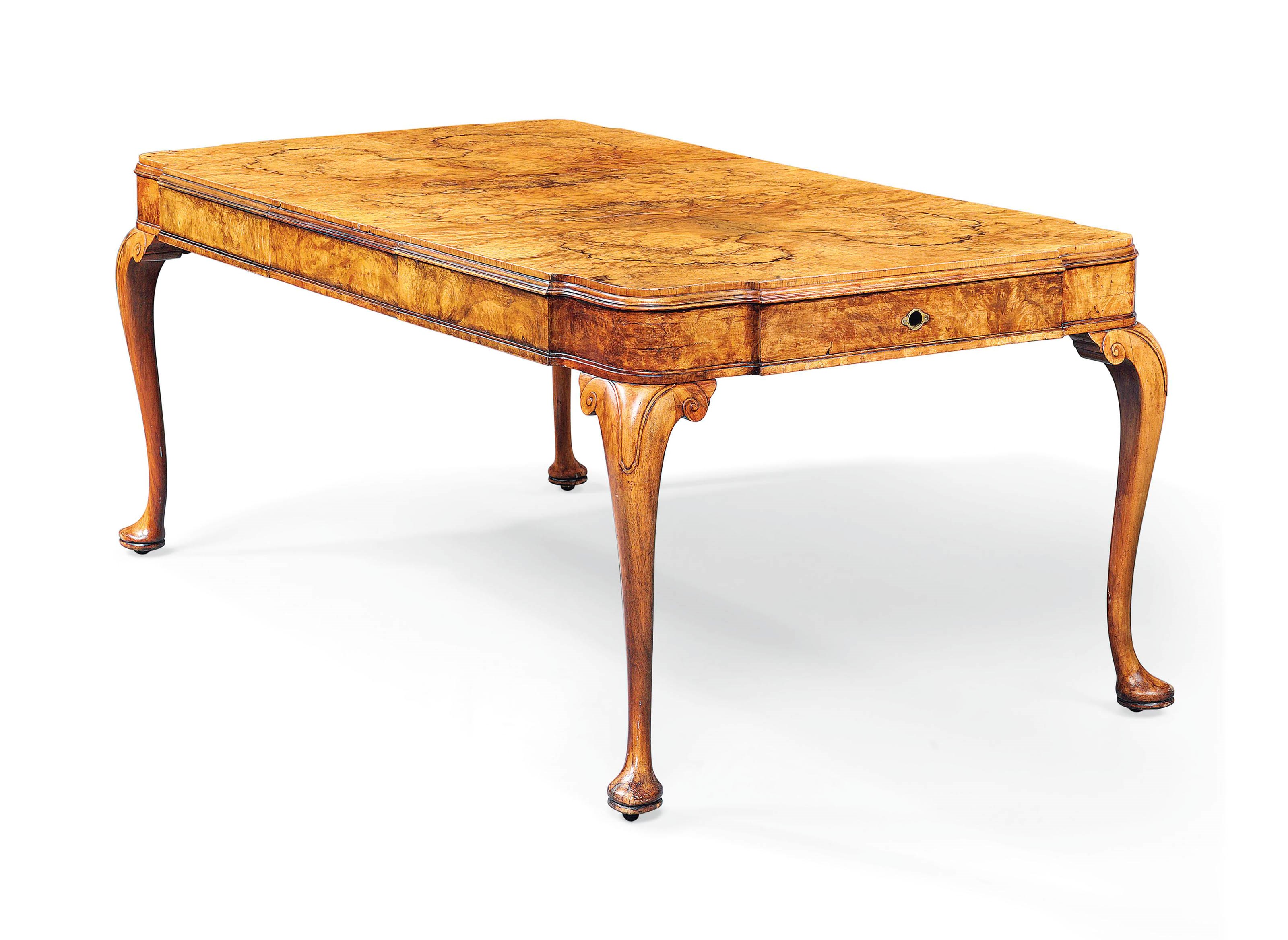 A FIGURED WALNUT EXTENDING DINING TABLE