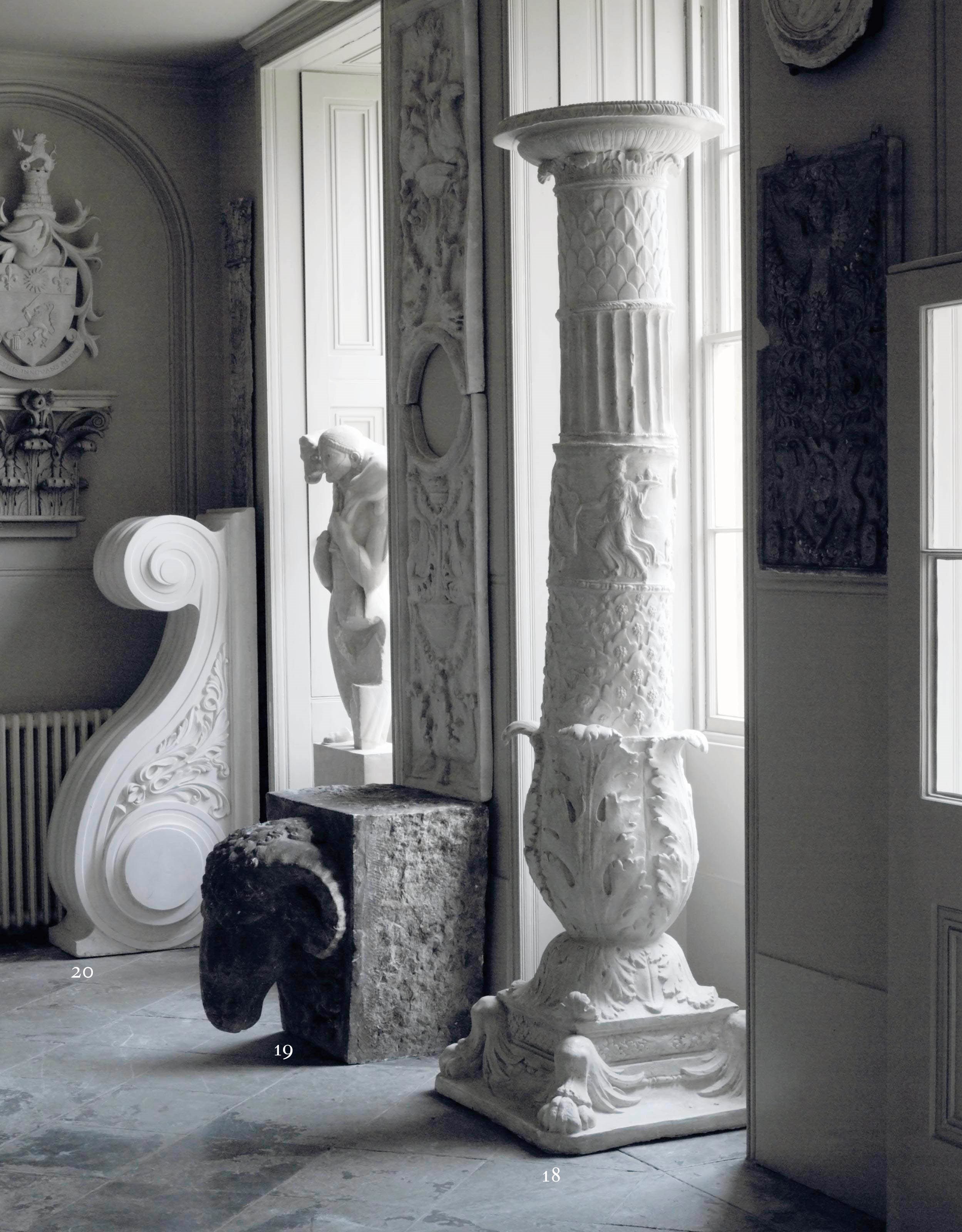A PAIR OF PLASTER LARGE TORCHERES