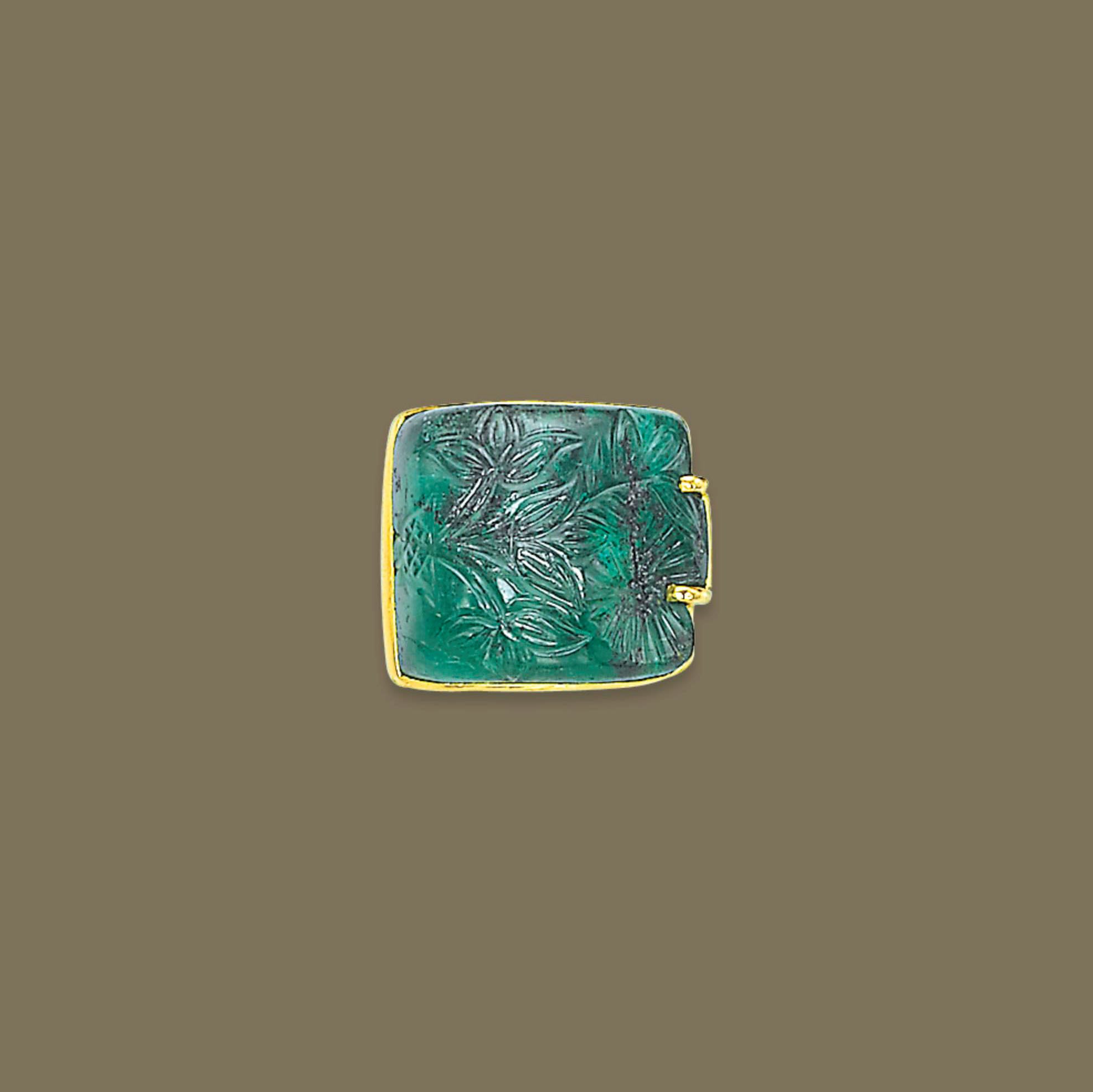 A CARVED EMERALD RING