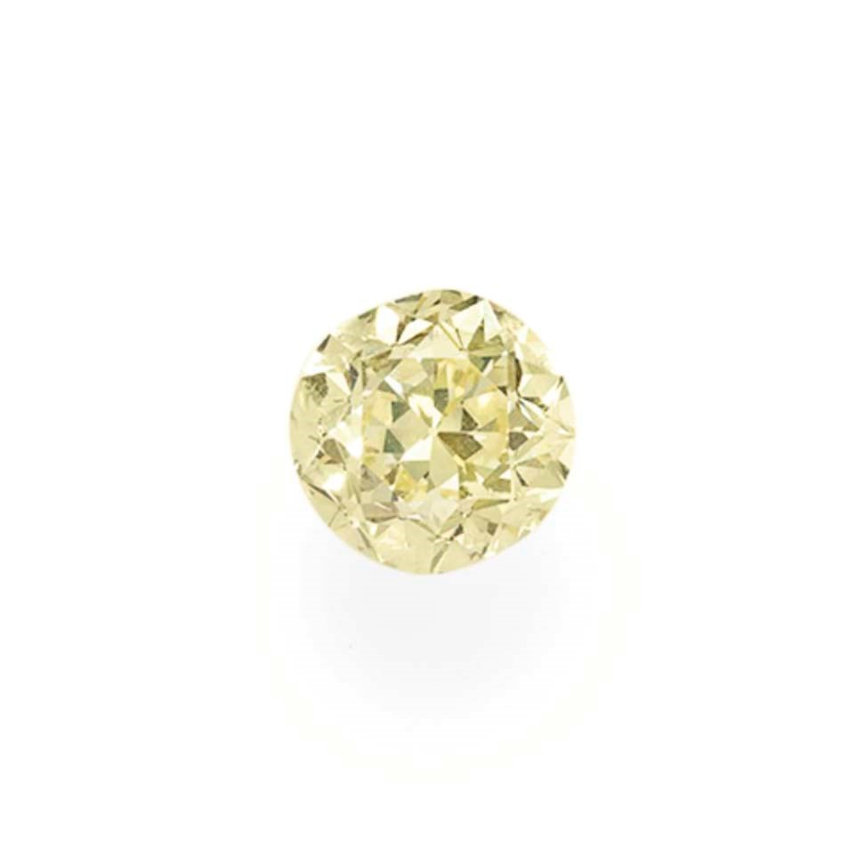 AN UNMOUNTED CIRCULAR-CUT COLORED DIAMOND