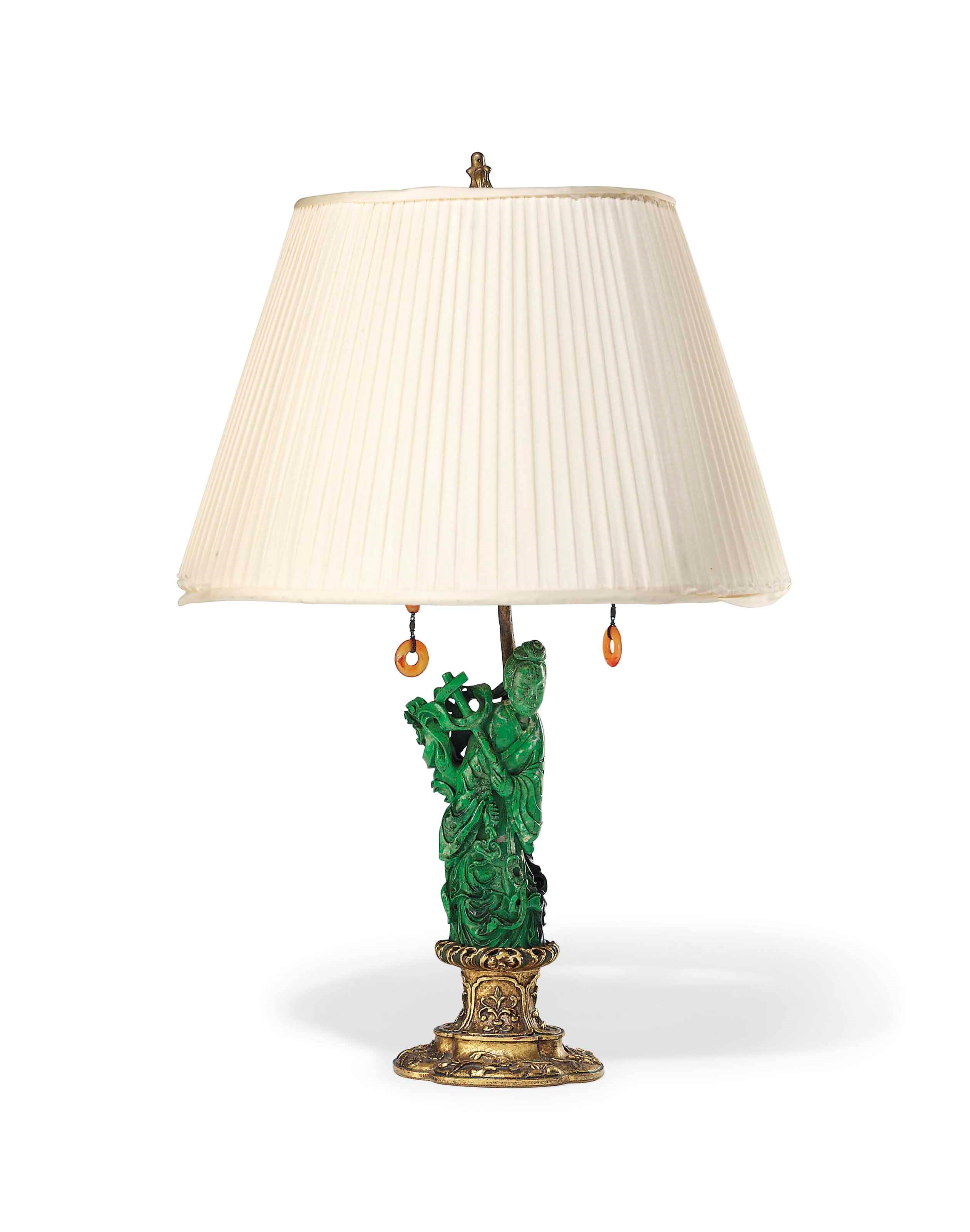 A CHINESE GREEN HARDSTONE CARVING OF A FEMALE IMMORTAL MOUNTED AS A LAMP