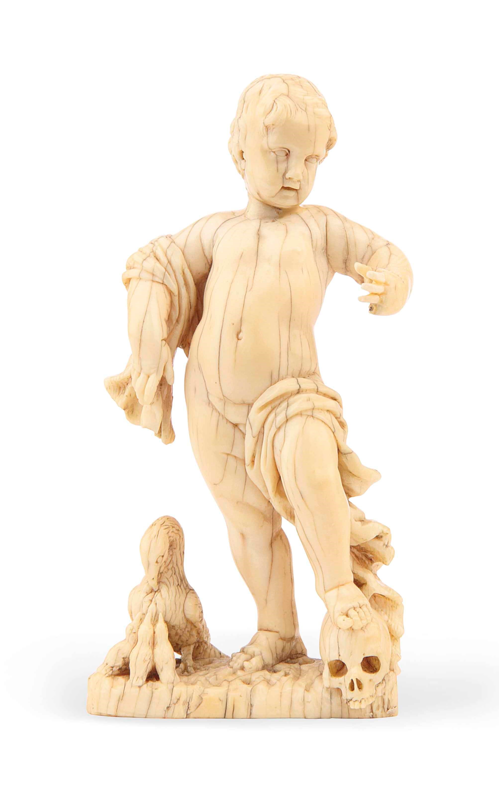 A CARVED IVORY FIGURE OF A PUTTO