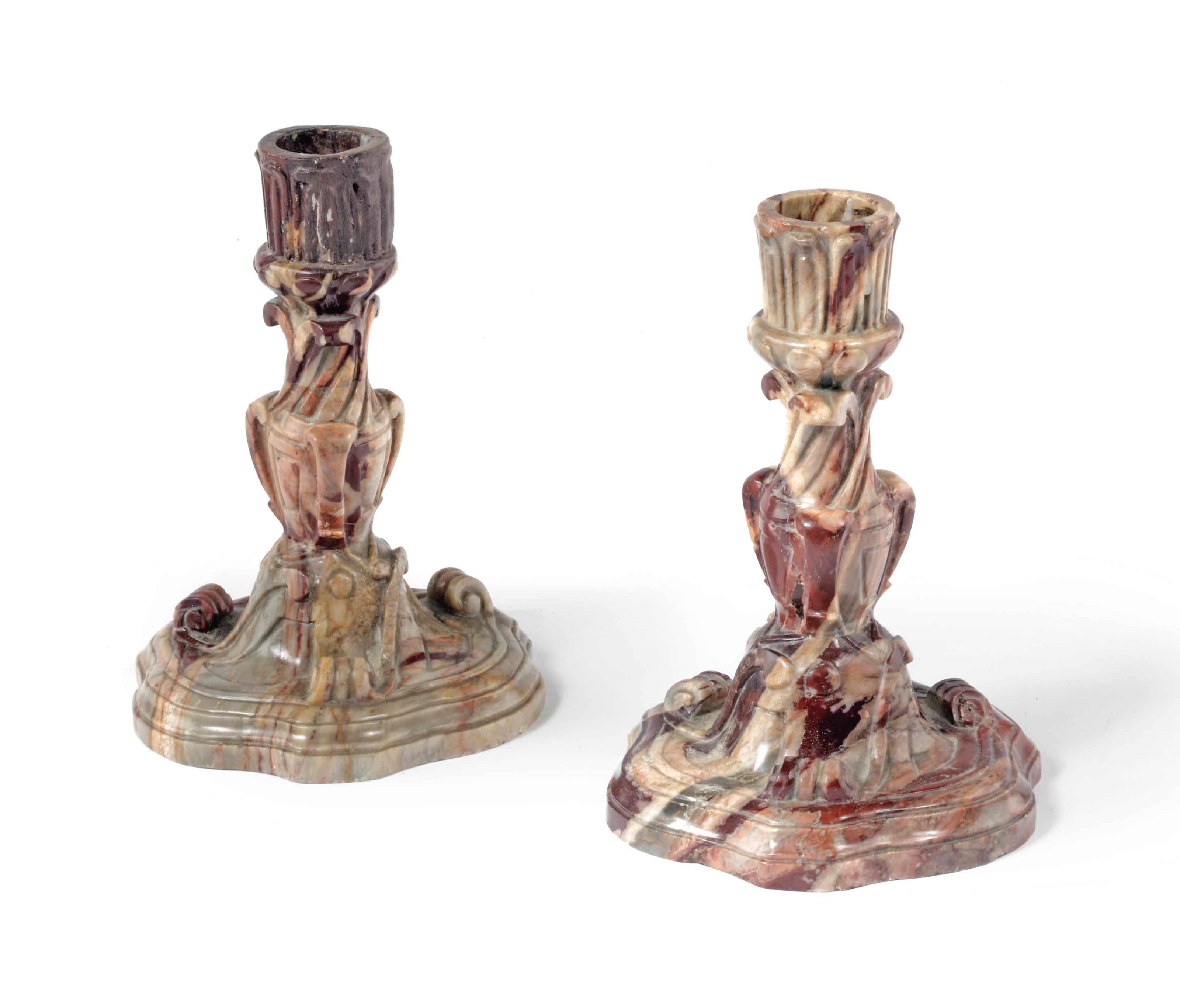 A pair of carved marble candlesticks