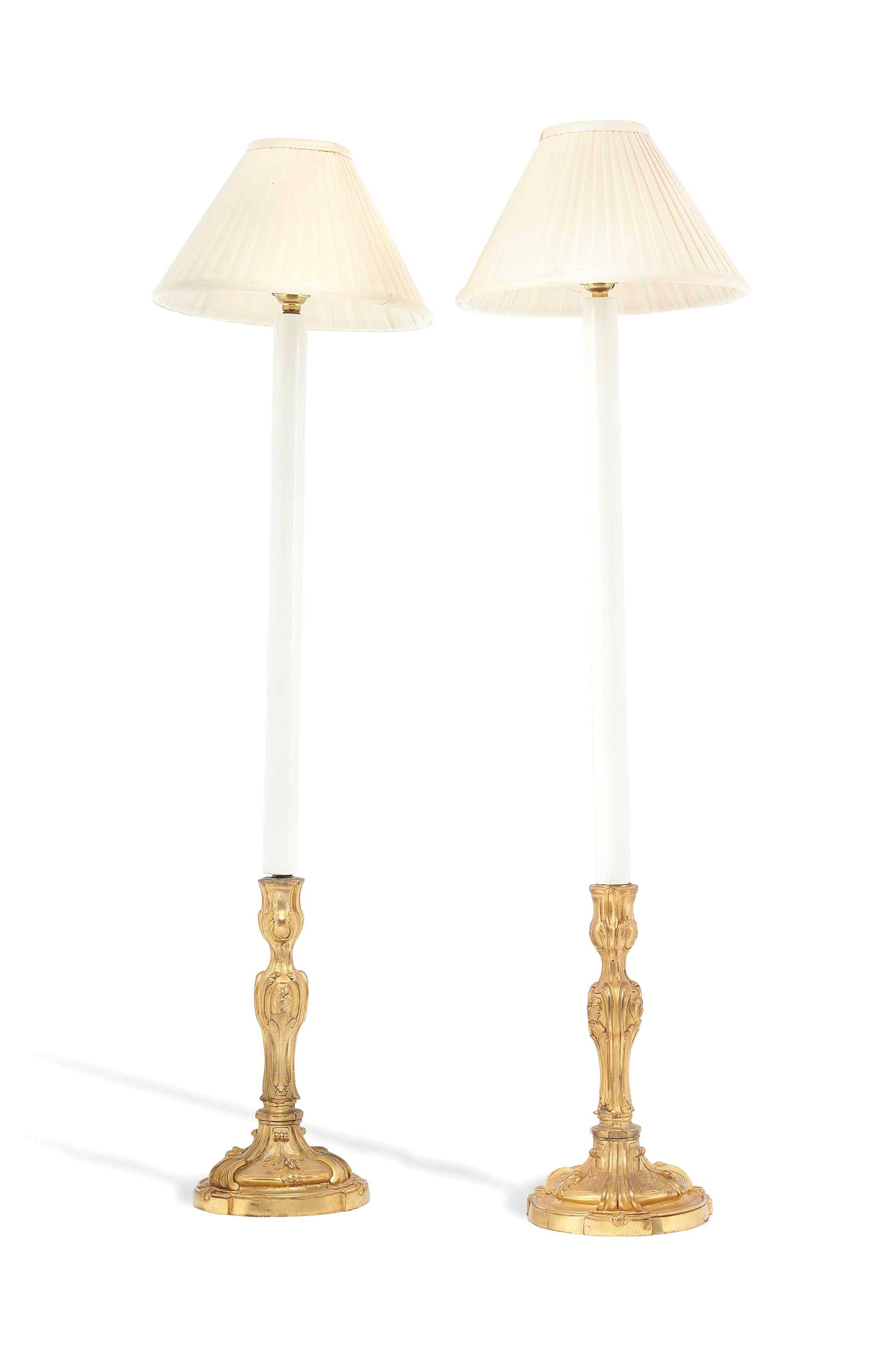 A PAIR OF REGENCE-STYLE ORMOLU CANDLESTICKS