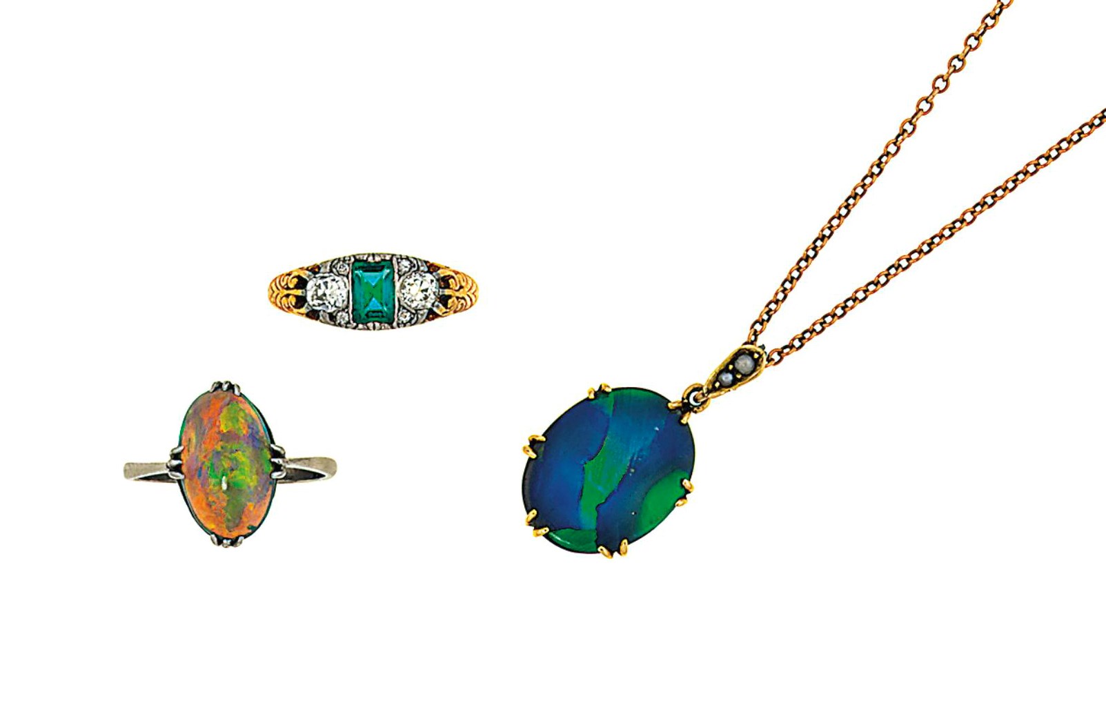 An opal ring, an opal pendant and and an emerald and diamond ring