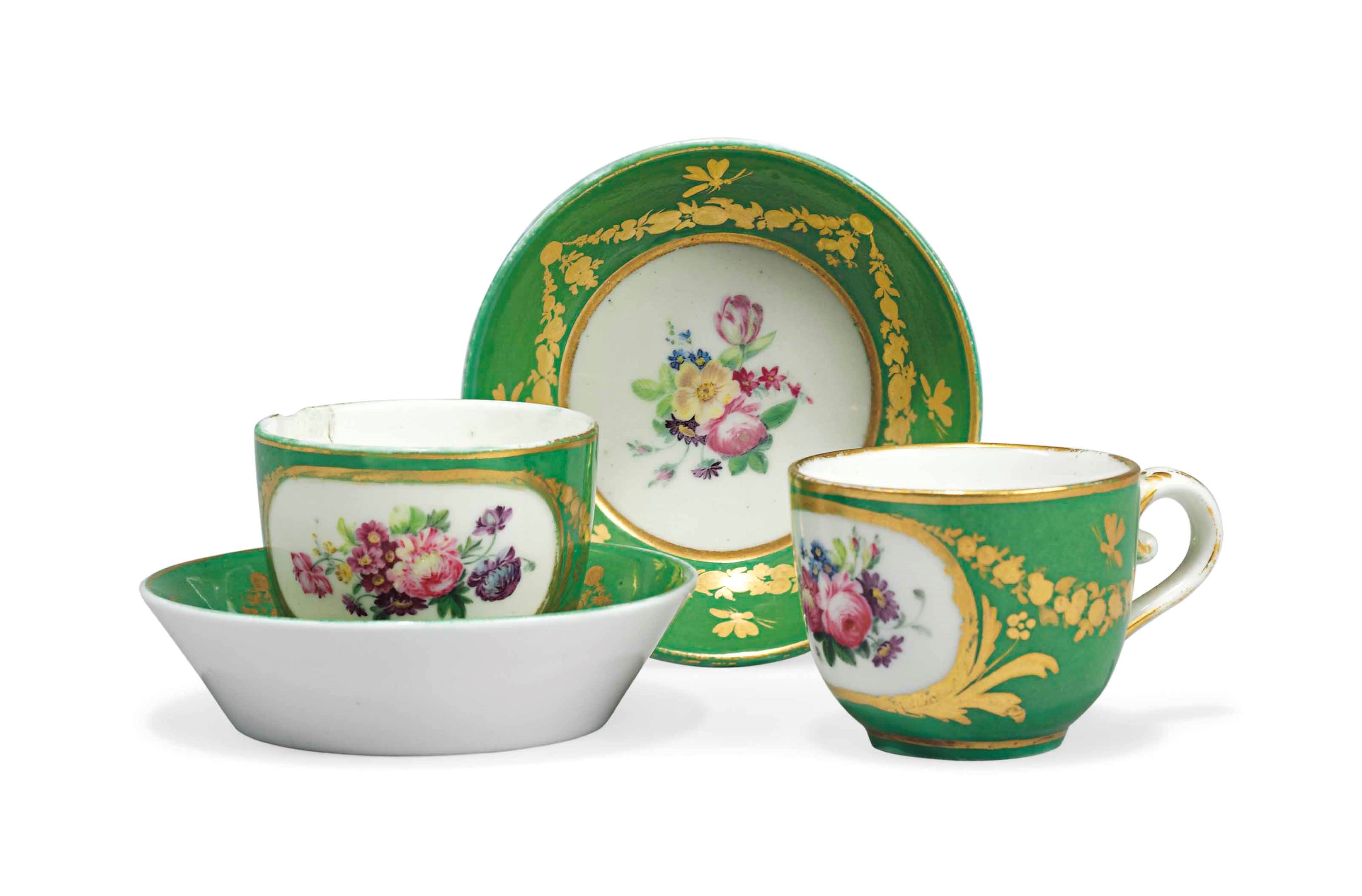 TWO SEVRES GREEN-GROUND MINIATURE CUPS AND SAUCERS