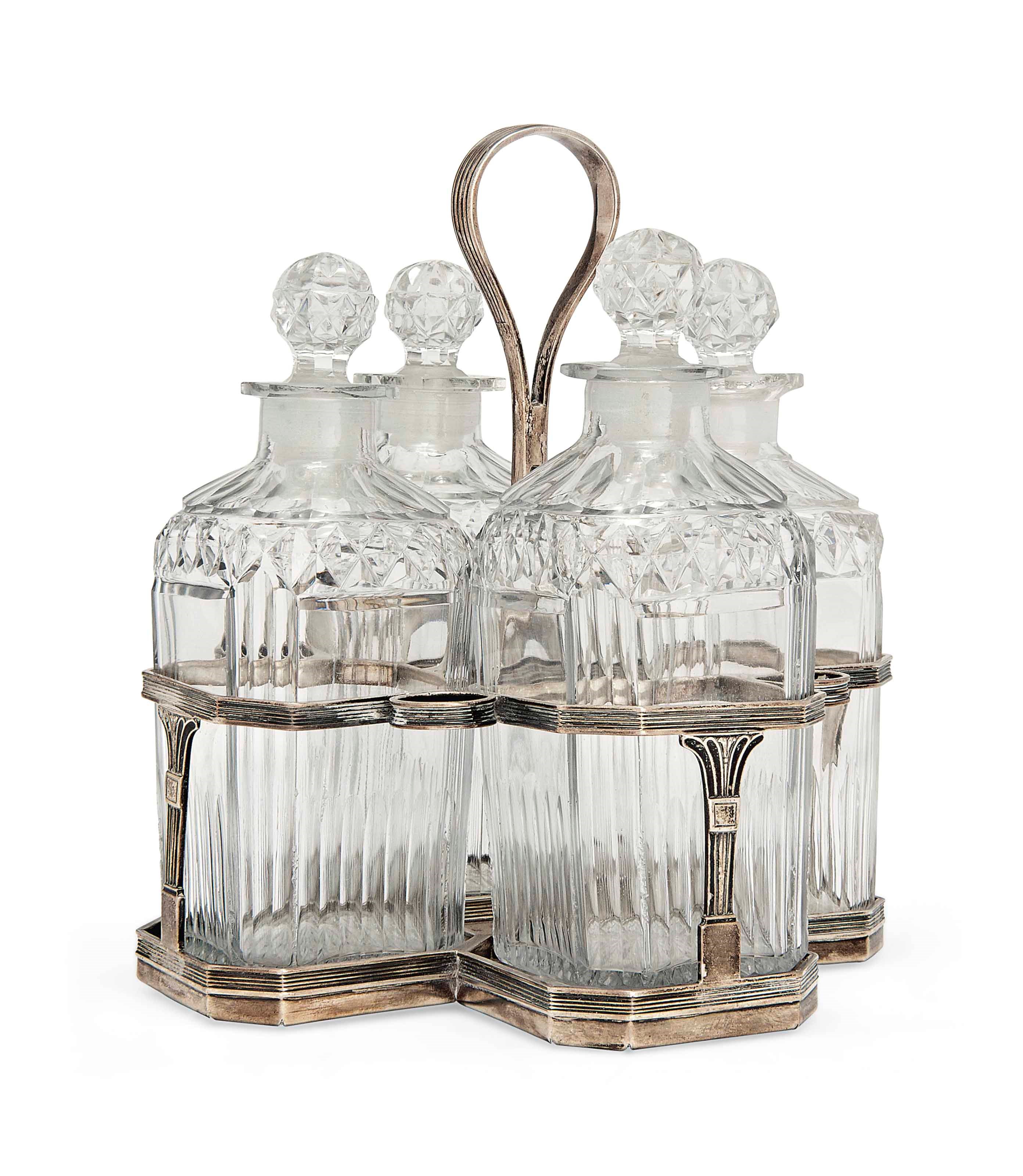 A GEORGE III SILVER FOUR-BOTTLE DECANTER STAND