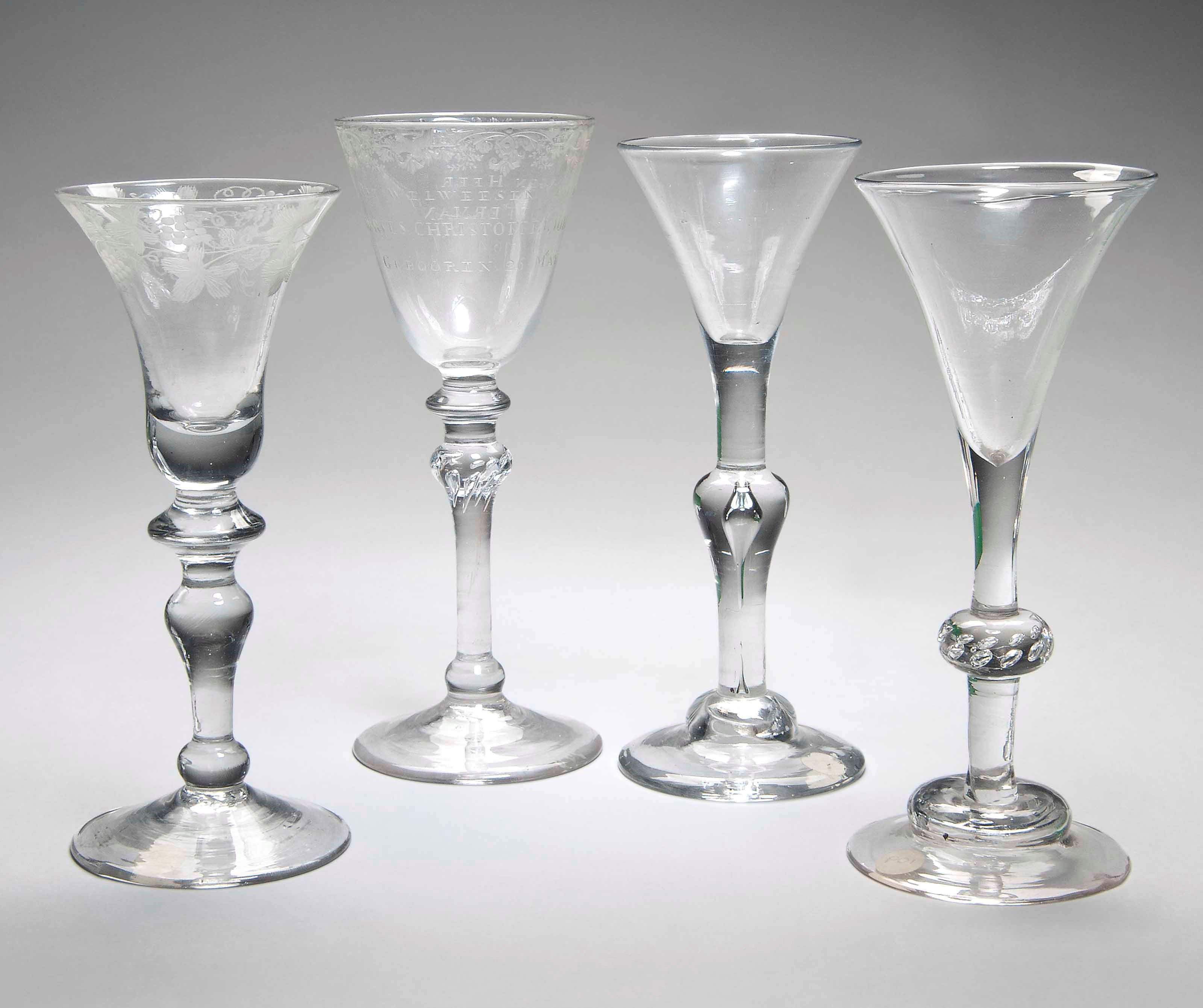 A DUTCH-ENGRAVED AND DATED LIGHT-BALUSTER WINE GLASS AND THREE BALUSTER WINE GLASSES