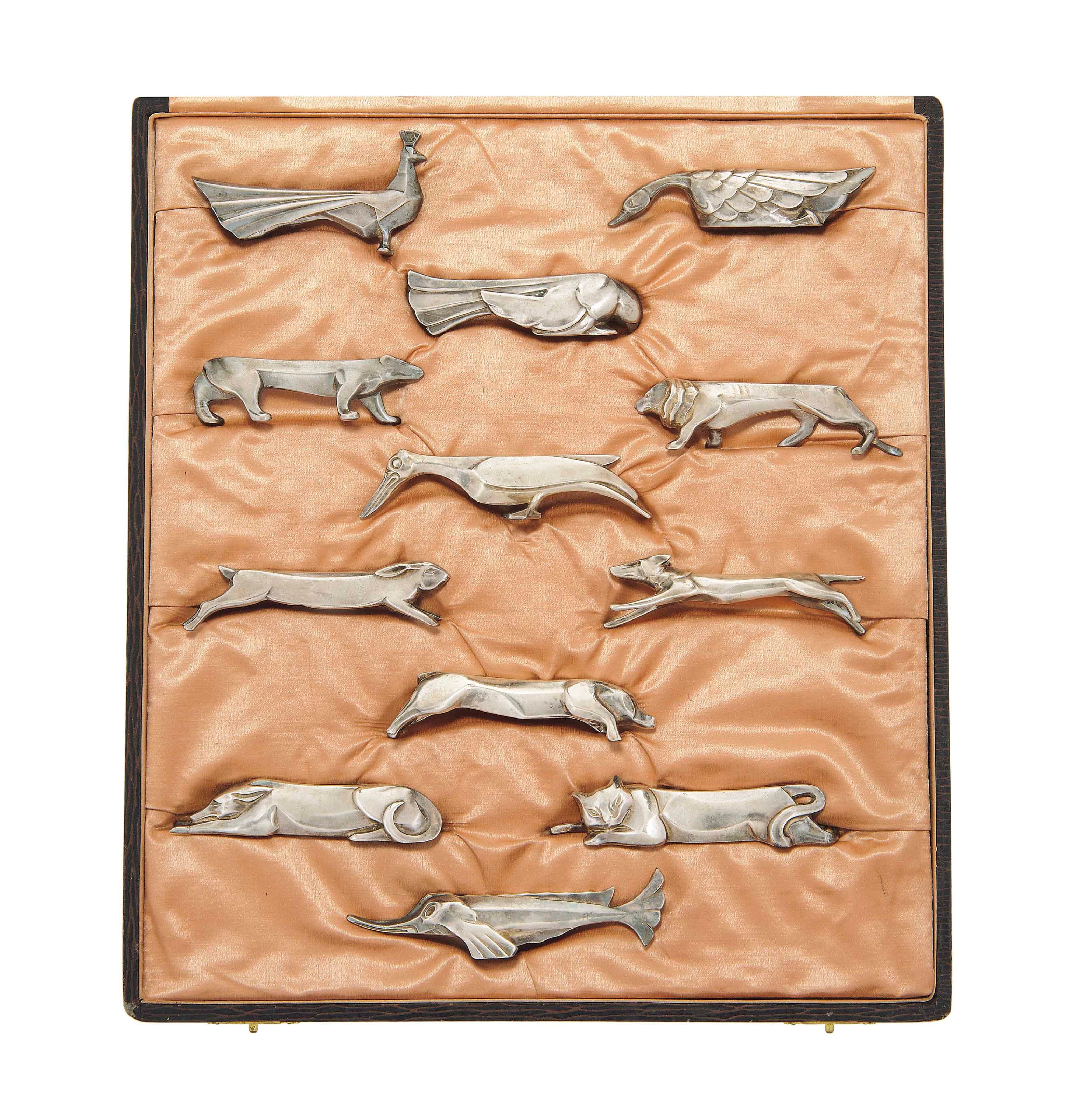 A BOXED SET OF CHRISTOFLE SILVER PLATED KNIFE RESTS