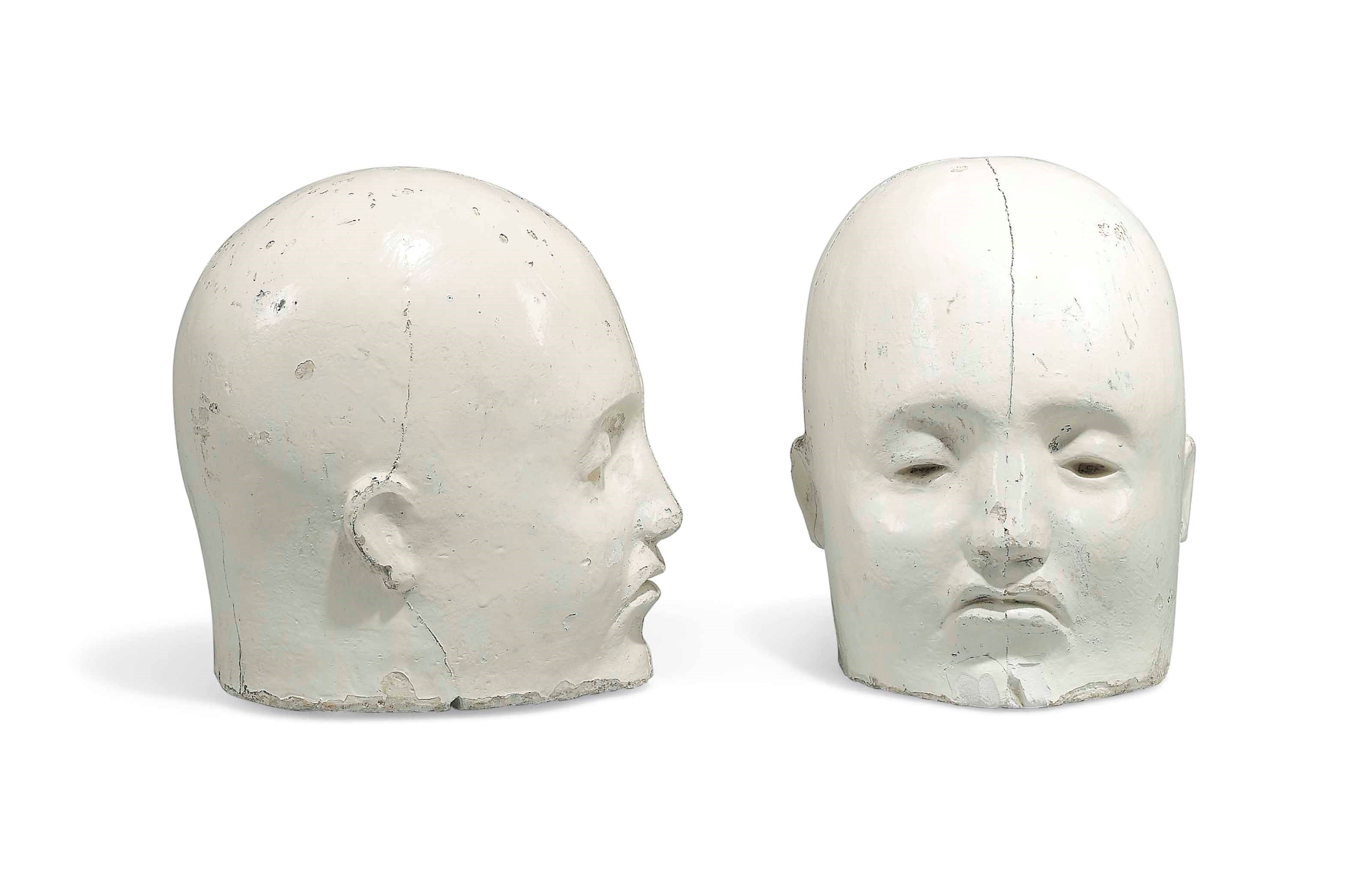 A PAIR OF WHITE-PAINTED COMPOSITION STONE HEADS