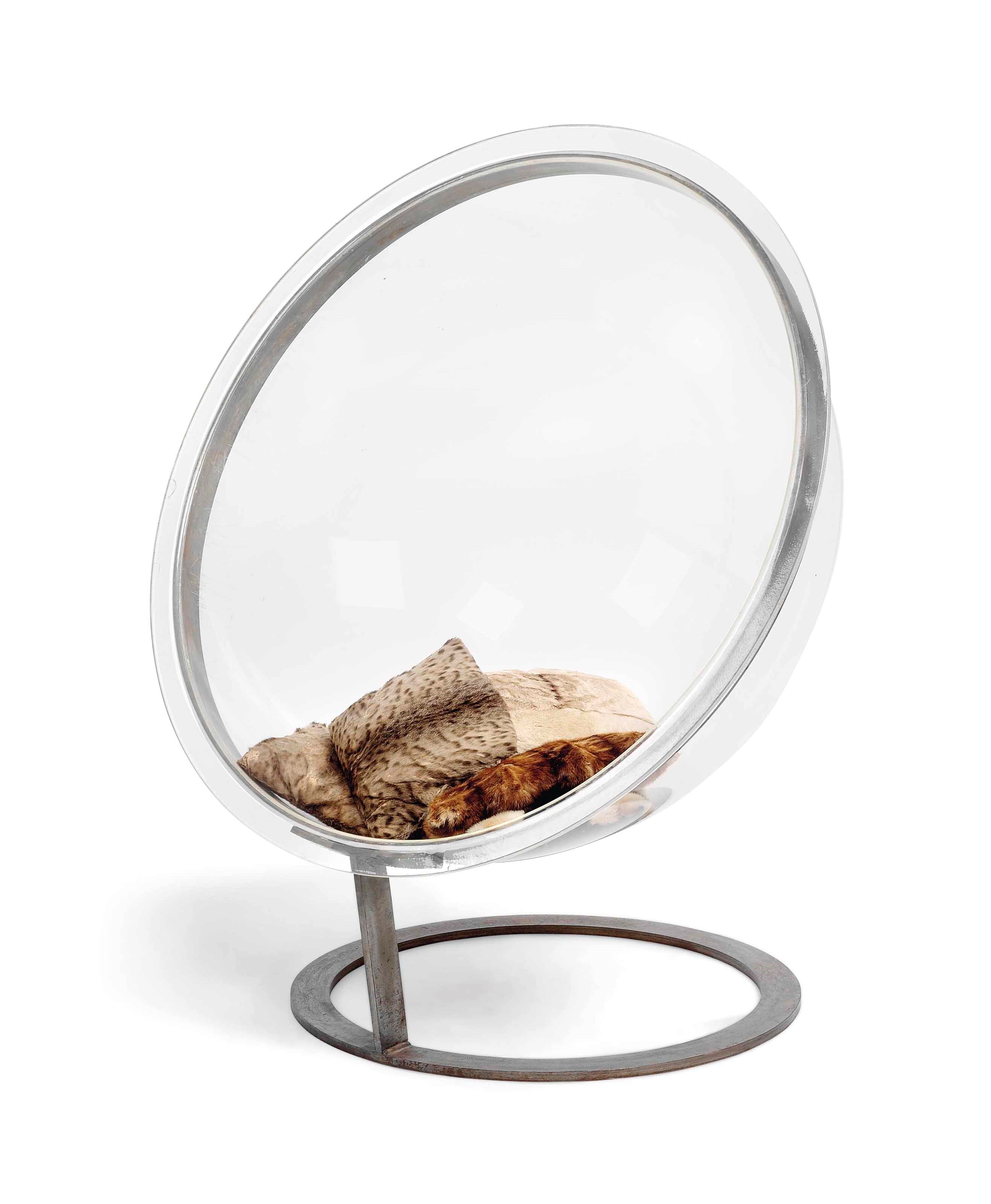 A HEMISPHERICAL PERSPEX AND STEEL LOUNGE CHAIR
